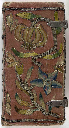 Front cover of 17th century embroidered satin book with two sets of metal clasps.