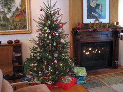 tree (decorated) and fireplace (with candles) on Christmas morning