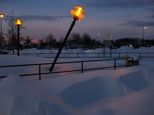Leaning Lamp in Snowy Parking Lot