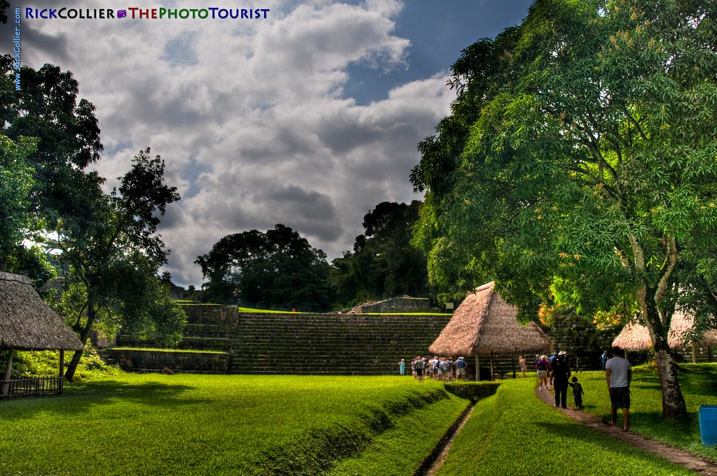 A tour group explores the grounds approaching the temple stairs at Quirigua Archeological Park in central Guatemala (HDR image).