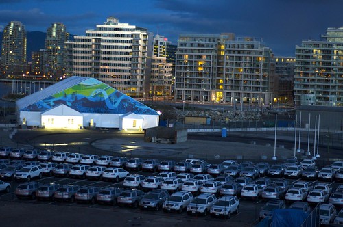Fleet of official vehicles outside Olympic Village tent