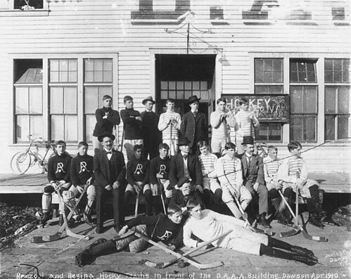 Renzoni and Regina hockey teams posed with their equipment in front of the Dawson Amateur Athletic Association building