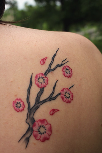 Tattoos blossom design on women back