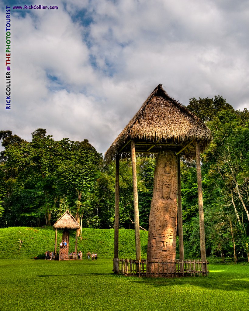 High dynamic range (HDR) image:  Thatched roofs and ancient Mayan stelae dot the lawn at Quirigua Archaeological Park in central Guatemala.