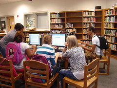 Students using computers before school. by TDHS Library