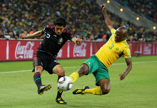 Tsepo Masilela of South Africa challenges Ricardo Osorio of Mexico during the 2010 