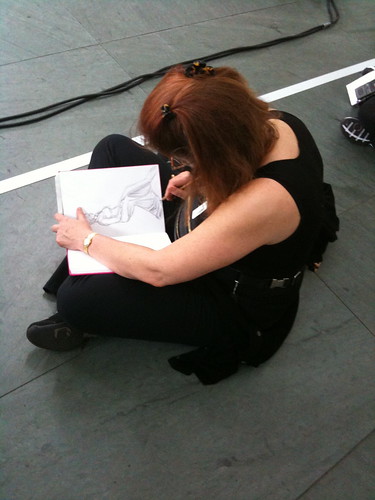 Young woman sketching Marina Abramovic's "The Artist Is Present"