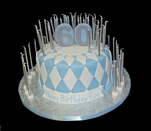 white blue and silver 60th birthday cake with 60 candles