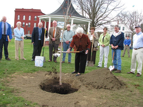 Town of Lyndon Selectboard member, Martha “Marty” Feltus, takes her turn supplementing the soil with Class A Sludge for the Red Maple tree planted at Lyndon’s Bandstand Park in observance of Earth Day. Pictured left to right: Mark Koprowski, Community Programs Loan Specialist; Molly Lambert, USDA Rural Development State Director; Dick Lawrence and Howard Crawford, State of VT Representative for Caledonia County, VT; Kermit Fisher, Lyndon Selectboard; Jenny Nelson from the office of U.S. Senator Bernie Sanders; Rhonda Shipppee, Community Programs Director, USDA Rural Development; Tim Gaskins, Lyndon Village Trustee; and Edwin Betz, ARRA Engineer, USDA Rural Development. 