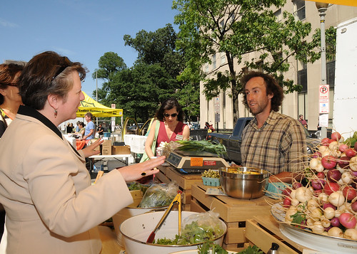 Agriculture Deputy Secretary Kathleen Merrigan wishes a vendor at the  Freshfarm Market on Vermont in Washington, D. C.,  Avenue by the White House good luck on his sales