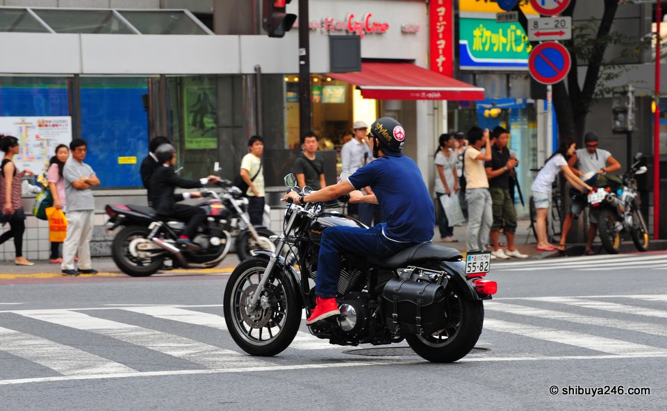 Harley through the streets. The satchel bag looks great on the back of this classic model