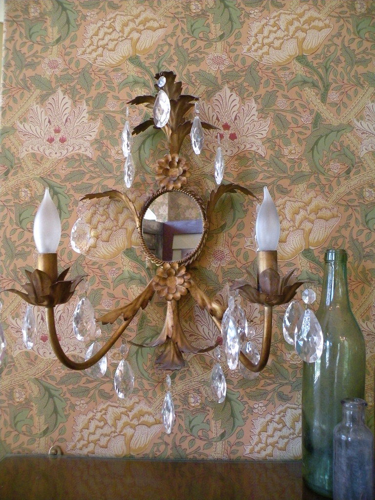 Detail of the William Morris wallpaper. The bottles were excavated from 