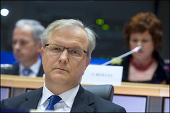 Mr Rehn listens carefully to a question posed ...