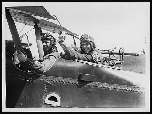 Cheery pilot and observer with their mascot pup ready for a flight over the German lines