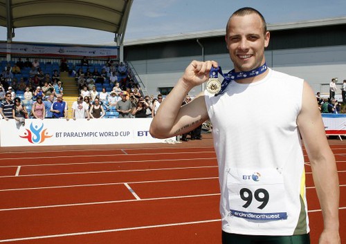 Oscar Pistorius shows off his medals on a sunny day at the track