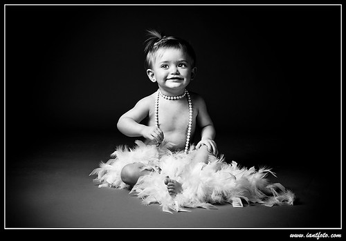 Toddler with pearls and feathers
