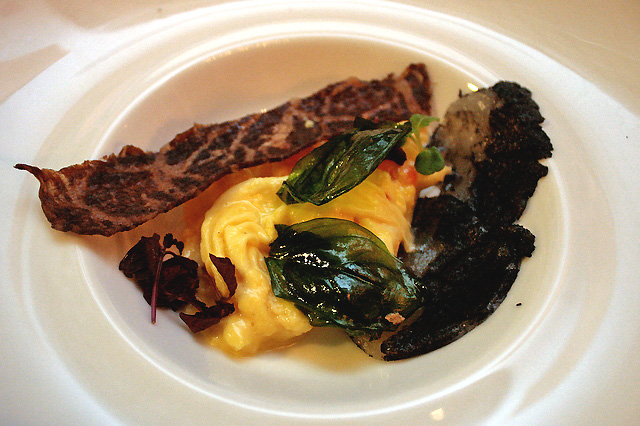 Hokkaido scallops cured with gunpowder, white pepper and caviar scrambled eggs, dehydrated wagyu and fried basil