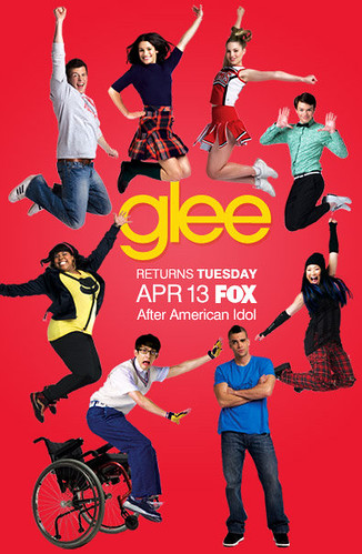 glee poster with singers jumping for joy against a red background. Artie, instead of jumping, is falling out of his wheelchair.