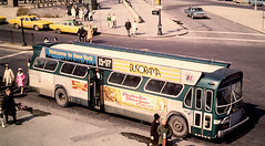 New York City Transit Authority 1960's era GMC "New Look" Fishbowl windshield bus with "Bat Wing" advertising panels tnear the roof. New York City.