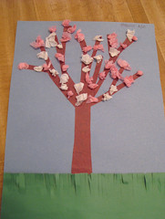 Construction paper tree filled with white and pink (tissue paper) blossoms, by Speck
