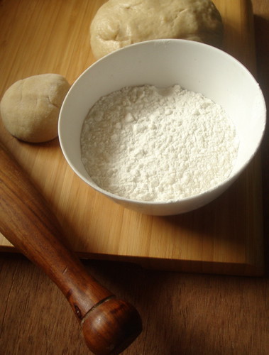 a pinch of raised dough and flour to dust,
 ready for rolling