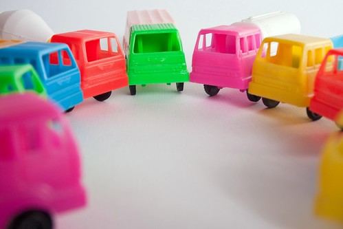 Council of toy trucks of different colors in circle