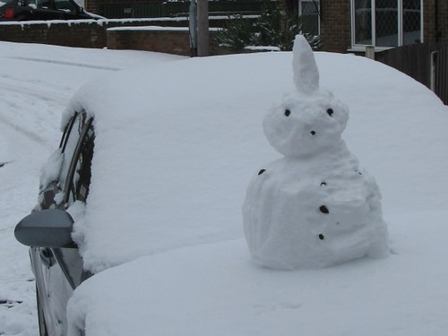 Punk snowman on car bonnet