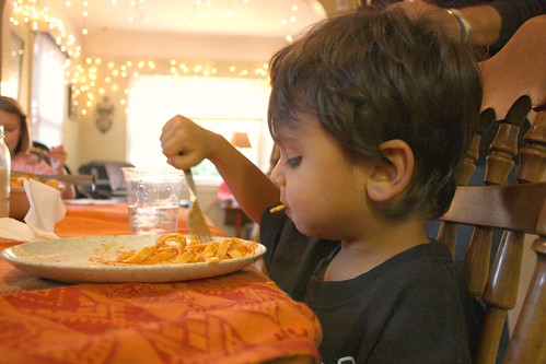 My cousins kid, eating pasta. If hes anything like his dad, these noodles are overdone.