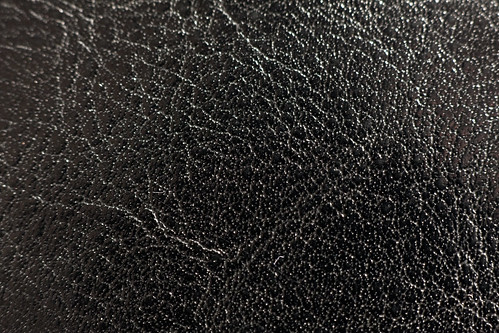 Shiny black leather texture on a suitcase