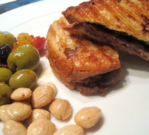 Prosciutto, Chive Goat Cream Cheese, and Baby Arugula Panini with Spanish Olives and Marcona Almonds