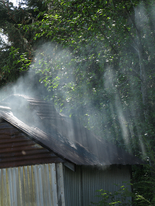 light hits smoke from a Kasaan smokehouse, Alaska