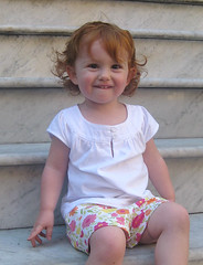 Speck, sitting on some city steps in colorfun shorts