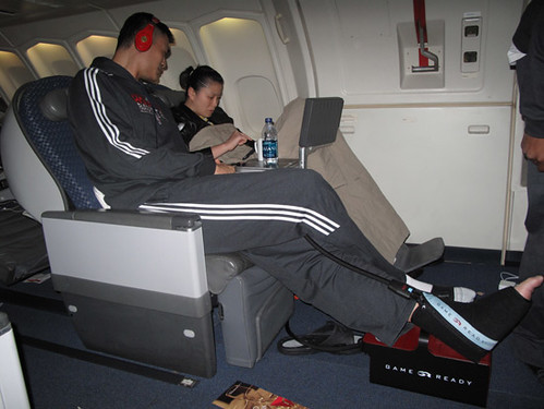 October 12th, 2010 - Yao Ming and wife Ye Li recline on the long flight from Houston to Beijing for the China Games