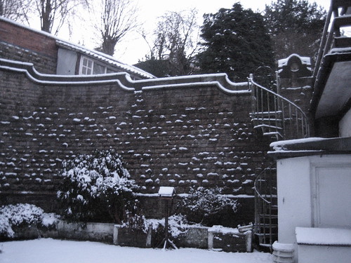coachhouse in snow - coutryard wall