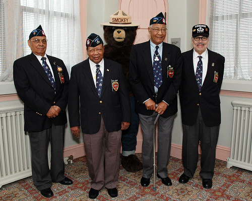 Former members of the 555th Parachute Infantry Regiment Smoke Jumpers, L to R Sergeant Clarence H. Beavers, National Triple Nickles Association President Joe Murchison, Smokey Bear, First Sergeant Walter Morris and Lt. Col Roger S. Walden. The Smoke Jumpers visited the U. S. Forest Service in Washington, D. C., on March 26, 2010. 