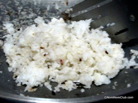 Add the cooked rice, salt, and pepper and stir together.
