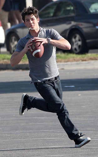 The Jonas Brothers Tossing A Football On Set by spunkransom2705.
