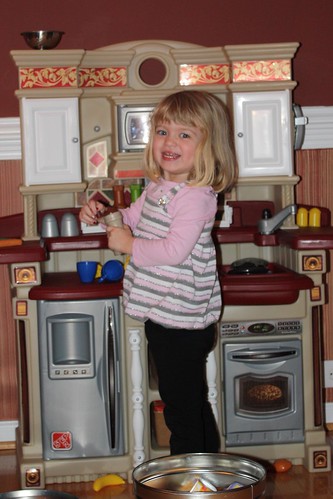loving her new toy kitchen
