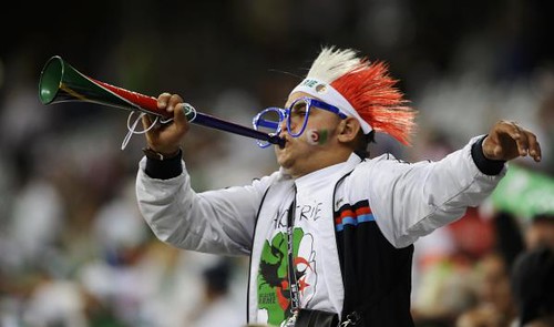 Algerian fan blows a vuvuzela, Algeria / England