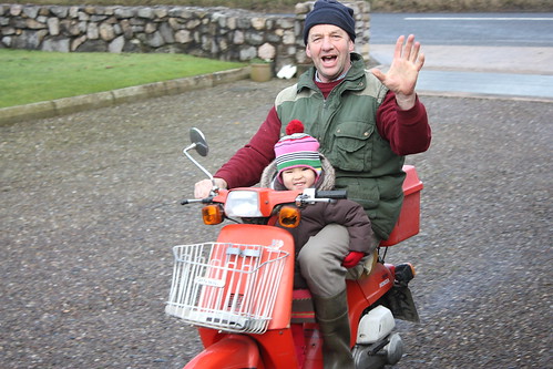 on the moped with papie