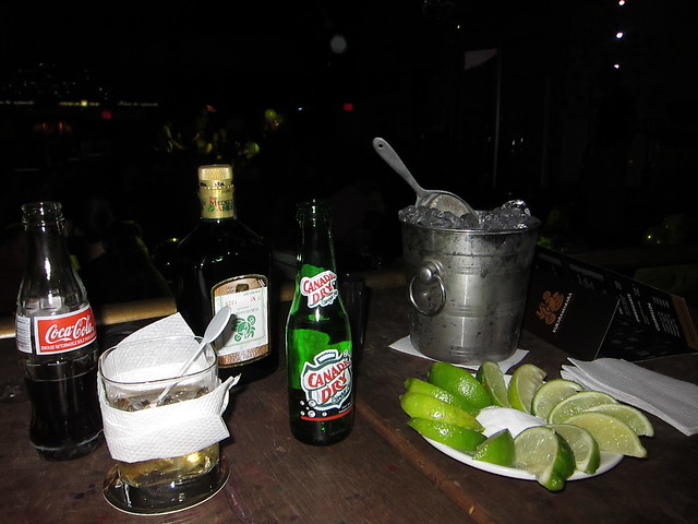 A bottle of Medellin Anejo Rum, sodas to mix, and a bucket of ice