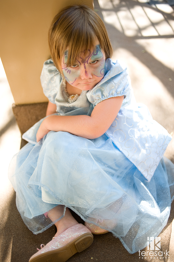 little girl sitting on the floor at disneyland