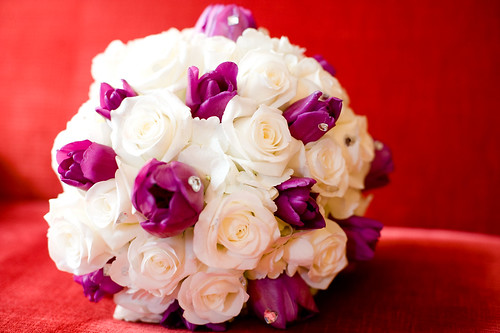 Wedding bouquet with white roses and purple tulips with rhinestones