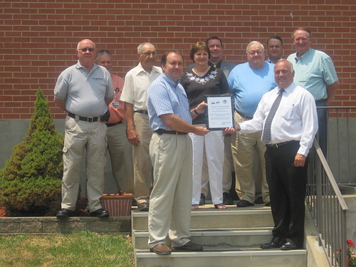 Certificate Presentation:   Row 1 (l to r):  Hardy Telecommunications General Manager D. Scott Sherman and USDA Rural Development State Director Bobby Lewis.  Row 2 (l to r):  Gerald Smith, Board Director; Arlie W. Funk, Board Secretary; Phyllis B. Cook, Board President; Loring E. Barr, Board Vice-President; and Harold Michael, Board Member.  Row 3 (l to r):  Greg Zirk, Board Member; Chris Strovel, Field Representative for Rep. Shelley Moore Capito; and Stanley Moyer, Hardy County Commission.