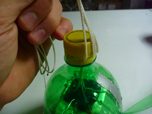the cap is holding the rope and adjusting the tension