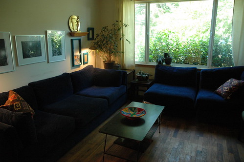 Casual living room, blue velvet sofas, wood floor, 1950's metal and wood record storage table, framed photos by Wonderlane, Seattle, Washington, USA by Wonderlane