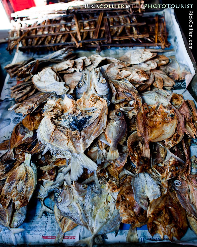 A pile of dried and cooked fish on a newspaper-covered table, in the Aertembaga Market, Bitung, North Sulawesi, Indonesia