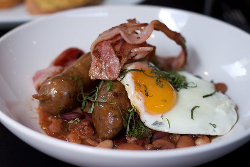 cassoulet with streaky bacon and an egg on top