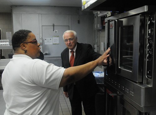 Jerrisa Carter shows Under Secretary Kevin Concannon new equipment purchased with ARRA funds. 