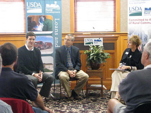 Noah Campbell, vice president of community relations for Utopian Wireless; Fred Witzig, co-coordinator of Monmouth College’s Midwest Matters initiative; and Colleen Callahan, Illinois state director of USDA Rural Development discuss the benefits of broadband access for rural communities at a public forum in Monmouth, Ill.